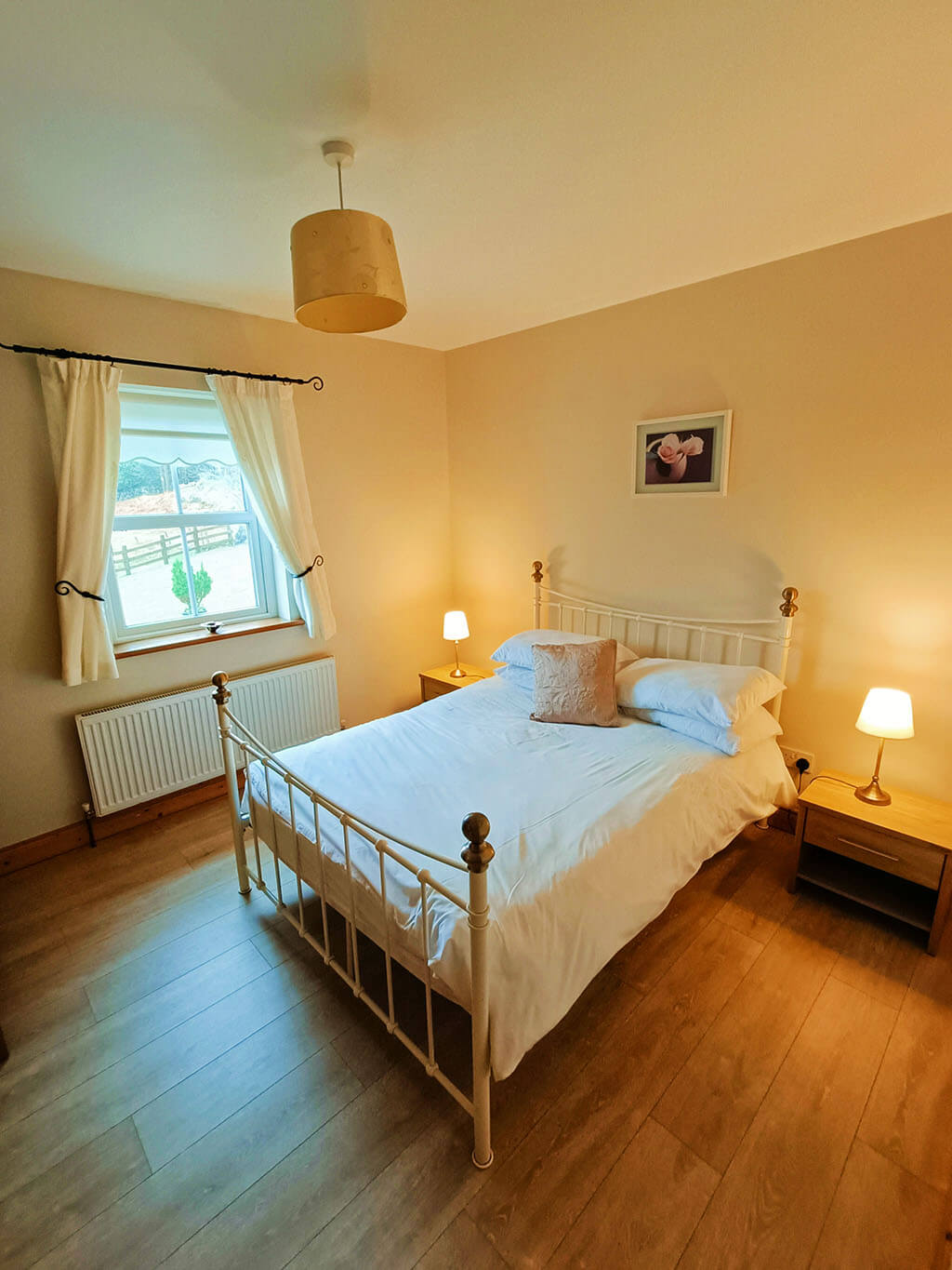 bedroom-double-bed-chair-window-wooden-floor-lamps-donegal-ireland-cottage