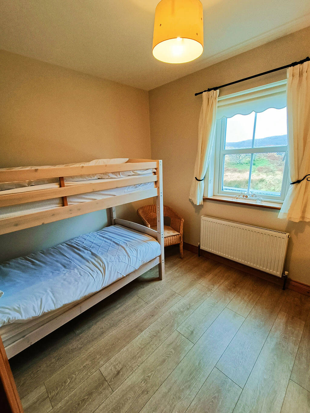bedroom-bunk-bed-chair-window-wooden-floor-lamps-donegal-ireland-cottage